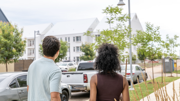 two people walking down a sidewalk in front of a building at The  Lindy at Wheeler